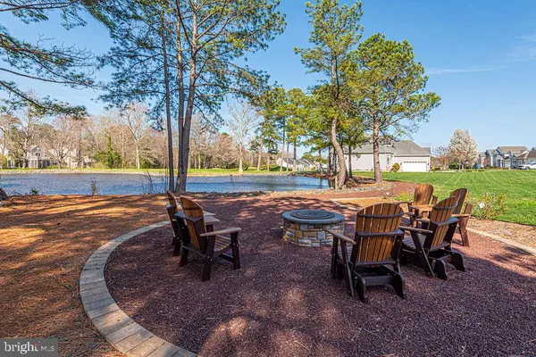 an outdoor sitting area with chairs and wooden fence