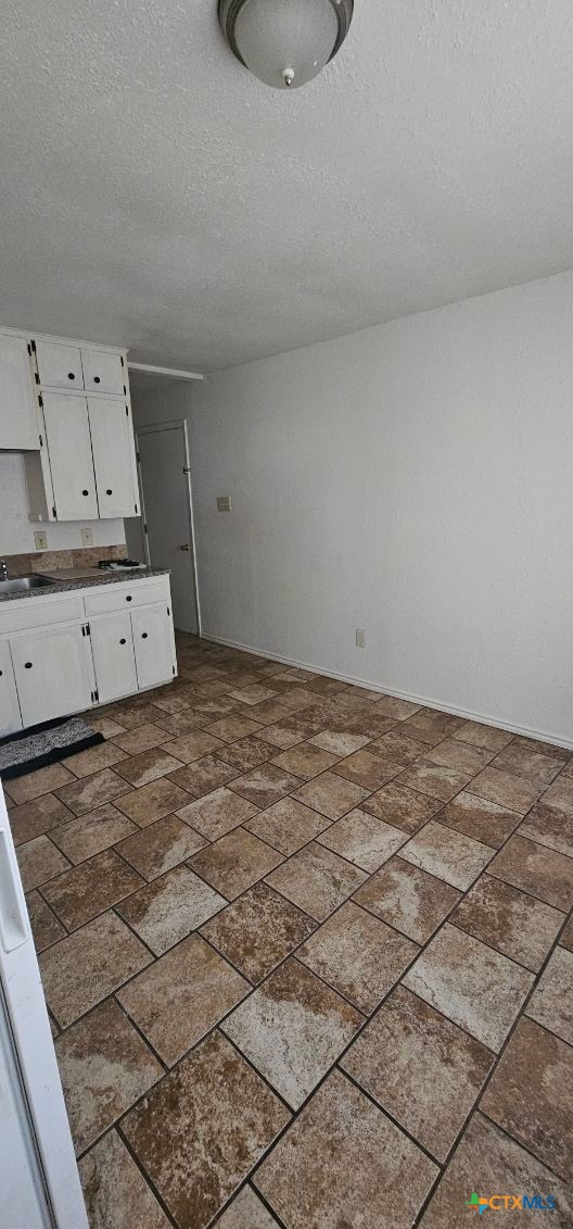 12 Sunset Drive Lampasas, TX 76550 - Photo 22 of 25 a room with a stove and cabinets