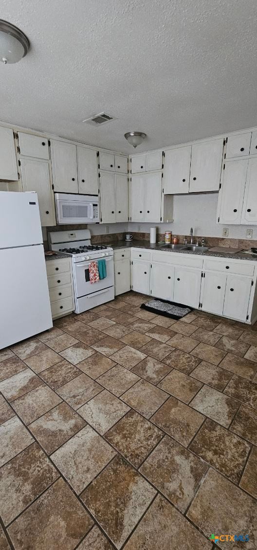 12 Sunset Drive Lampasas, TX 76550 - Photo 4 of 25 a kitchen with cabinets and a stove top oven