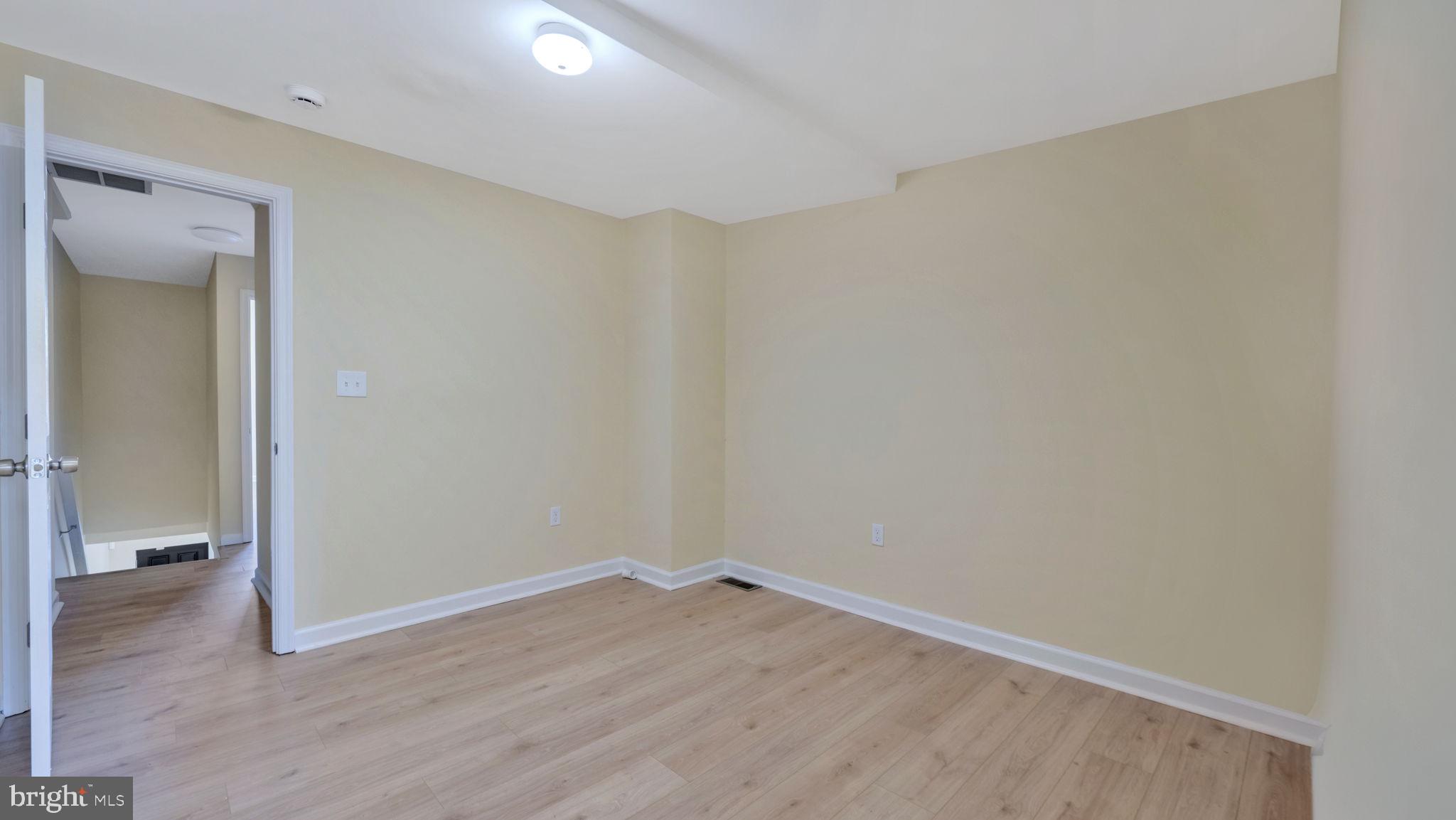 307 South Smallwood Street Baltimore, MD 21223 - Photo 7 of 19 a view of a room with wooden floor and a bathroom