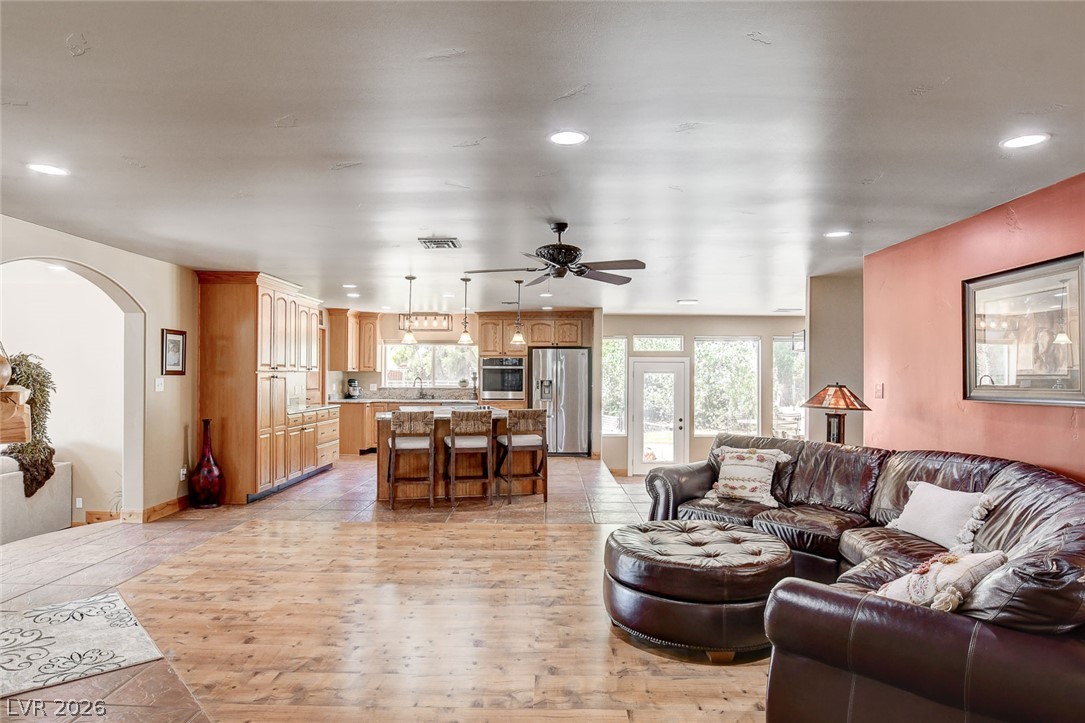 1950 Bowman Road Logandale, NV 89021 - Photo 12 of 81 An open-concept living space integrates a well-appointed kitchen with warm wooden cabinetry and a comfortable lounge area.