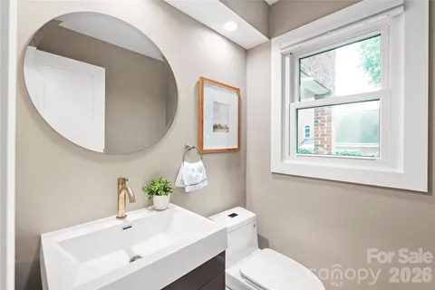a bathroom with a toilet a sink and a mirror