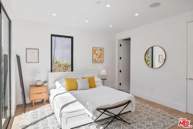 a bedroom with furniture and a window