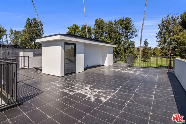 a view of a house with pool and chairs
