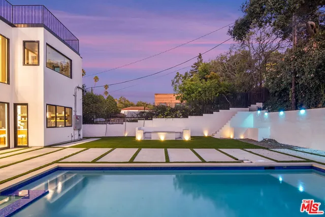 a view of swimming pool with a lounge chairs