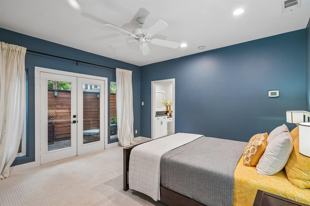 3553 Wheeler Street Dallas, TX 75209 - Photo 24 of 35 Primary suite with blue accent walls, ceiling fan, French doors to private patio, and en suite bath access