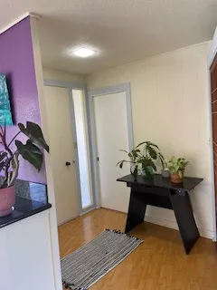 a room with painting on the wall and a potted plant