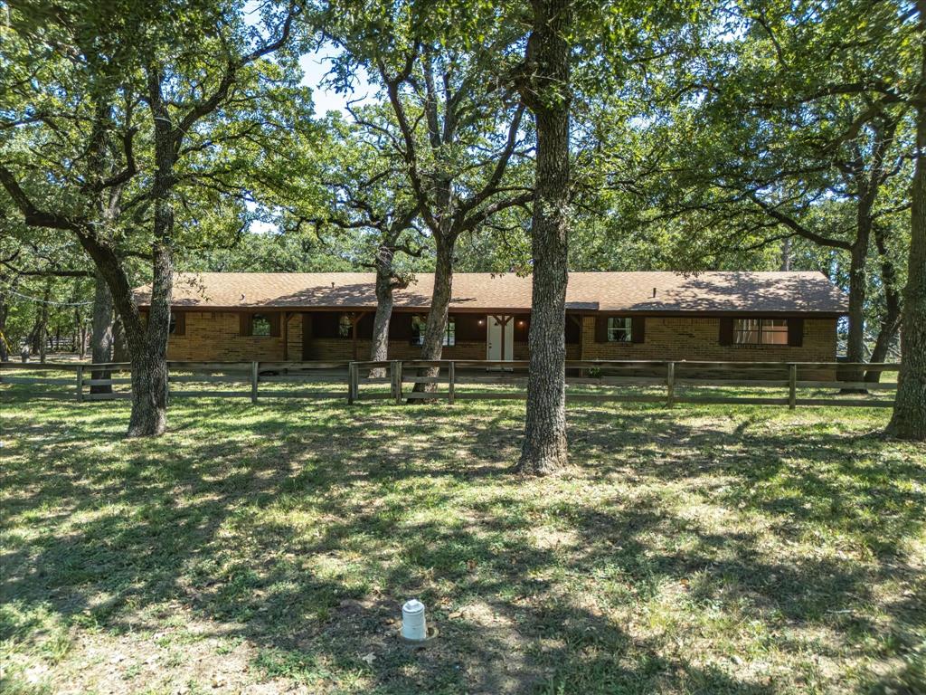 12580 Briar Road Azle, TX 76020 - Photo 1 of 1 Well-built brick home sits peacefully under a canopy of majestic, mature trees!