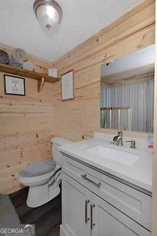 a bathroom with a sink a toilet and a mirror