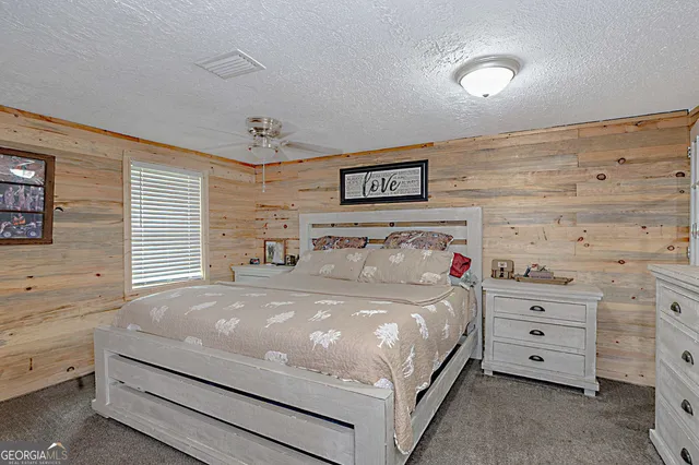 a large bed sitting in a bedroom next to a window