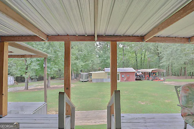 a view of a porch with furniture and garden