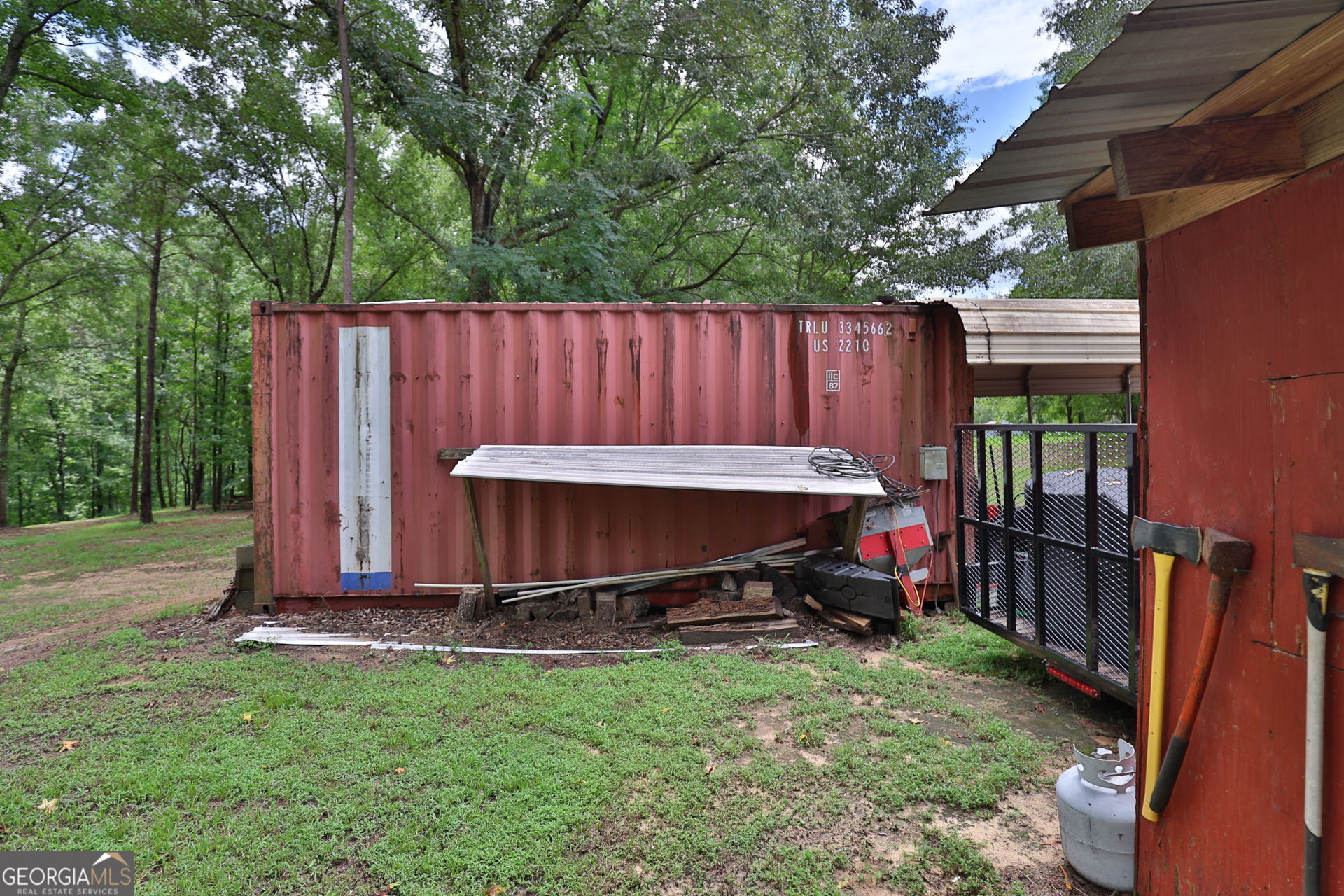 1455 McAllister Road Buena Vista, GA 31803 - Photo 38 of 45 a view of a backyard with a small cabin and a chair