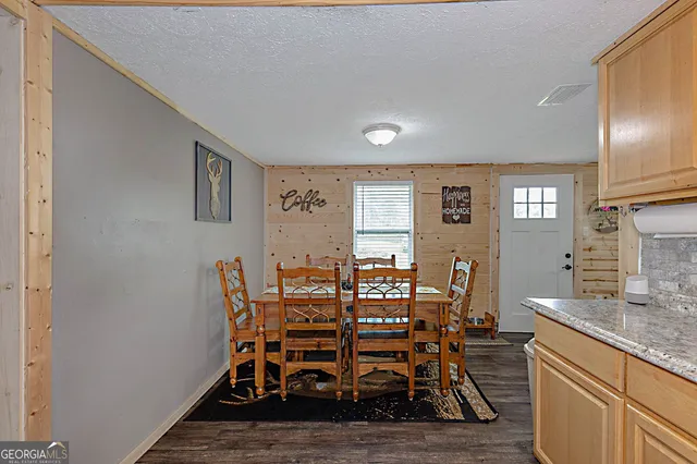 a dining room with furniture and wooden floor