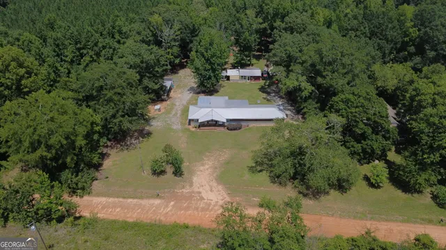 an aerial view of a house with a yard