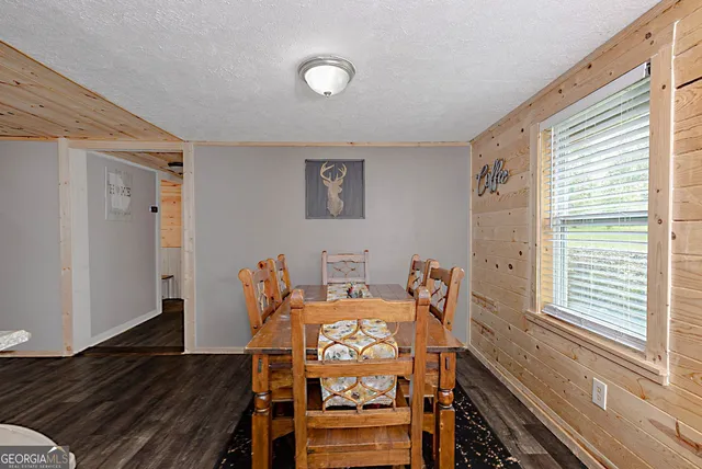 a view of a dining room with furniture a chandelier and wooden floor
