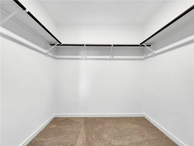 a view of an empty room and wooden floor