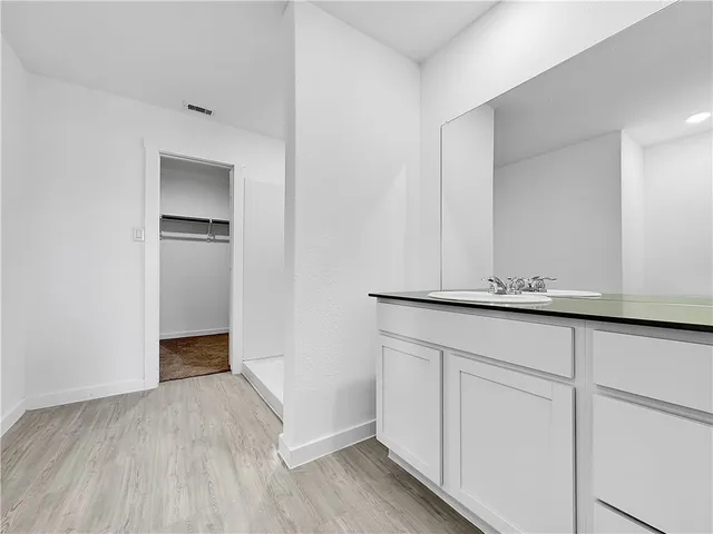 a bathroom with a tub shower and sink