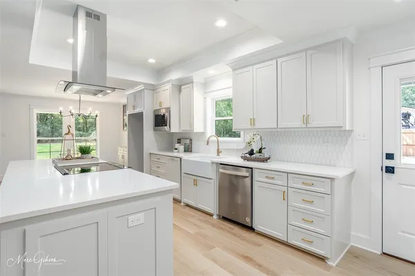 a kitchen with a sink stove and cabinets