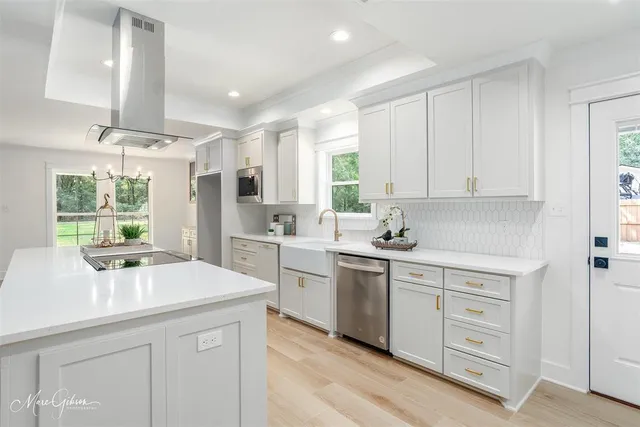 a kitchen with a sink stove and cabinets