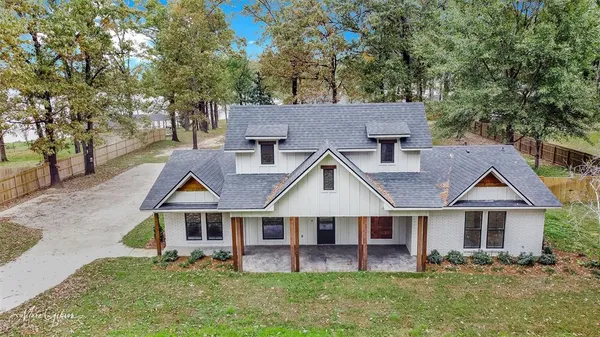 a view of a yard with wooden fence