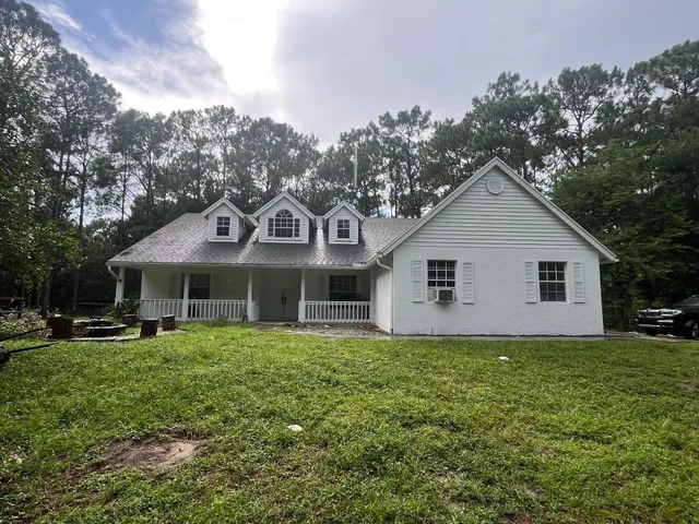 a front view of house with yard and green space