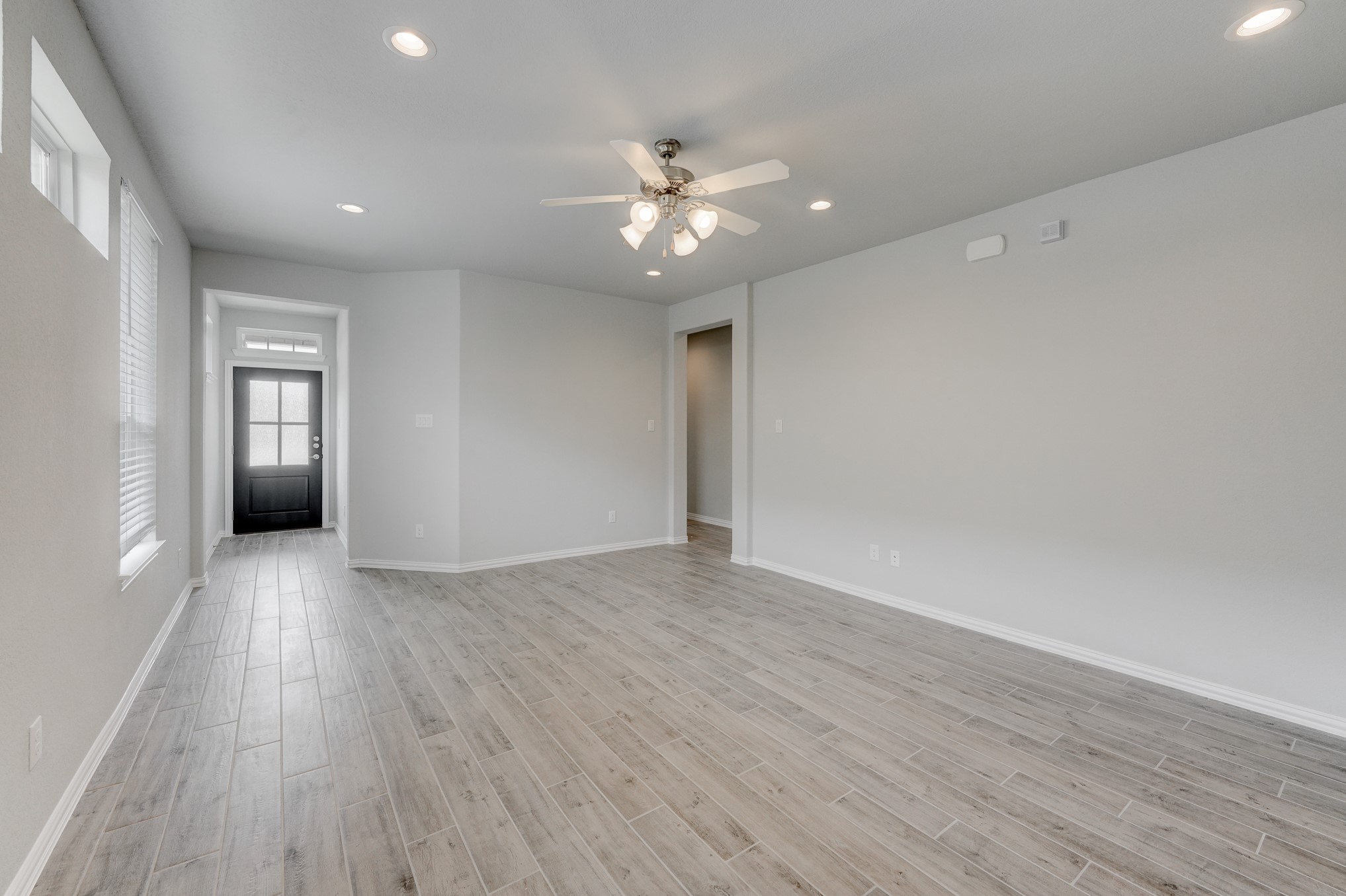 1229 Red Hills Drive Rosharon, TX 77583 - Photo 7 of 29 a view of an empty room with wooden floor and a ceiling fan