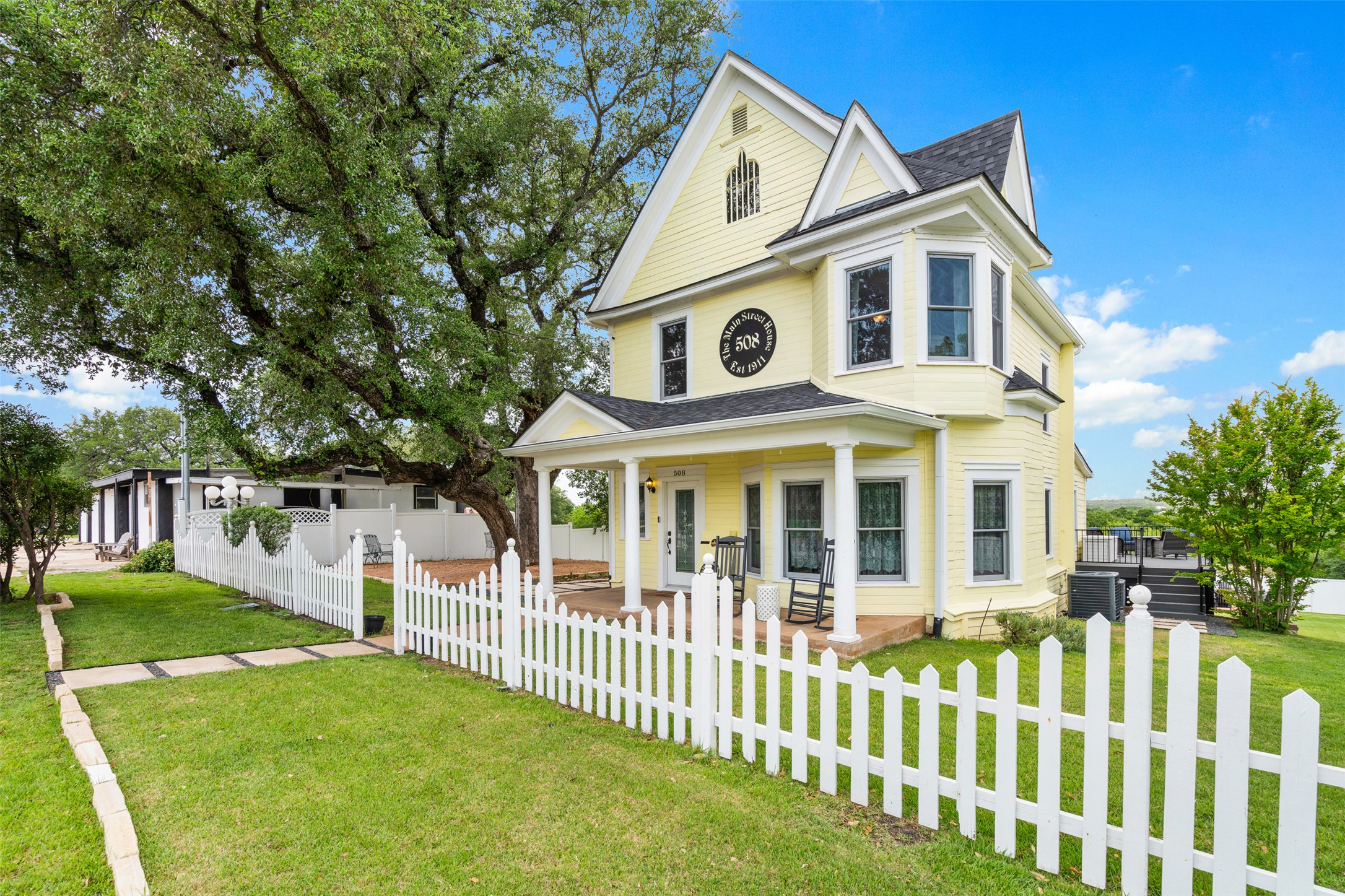 508 Main Street Marble Falls, TX 78654 - Photo 1 of 30 Victorian home featuring a porch a fenced front yard, and plenty of charm