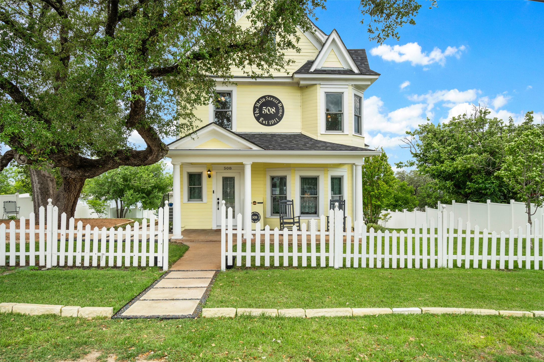 508 Main Street Marble Falls, TX 78654 - Photo 2 of 30 Victorian home featuring a porch a fenced front yard, and plenty of charm