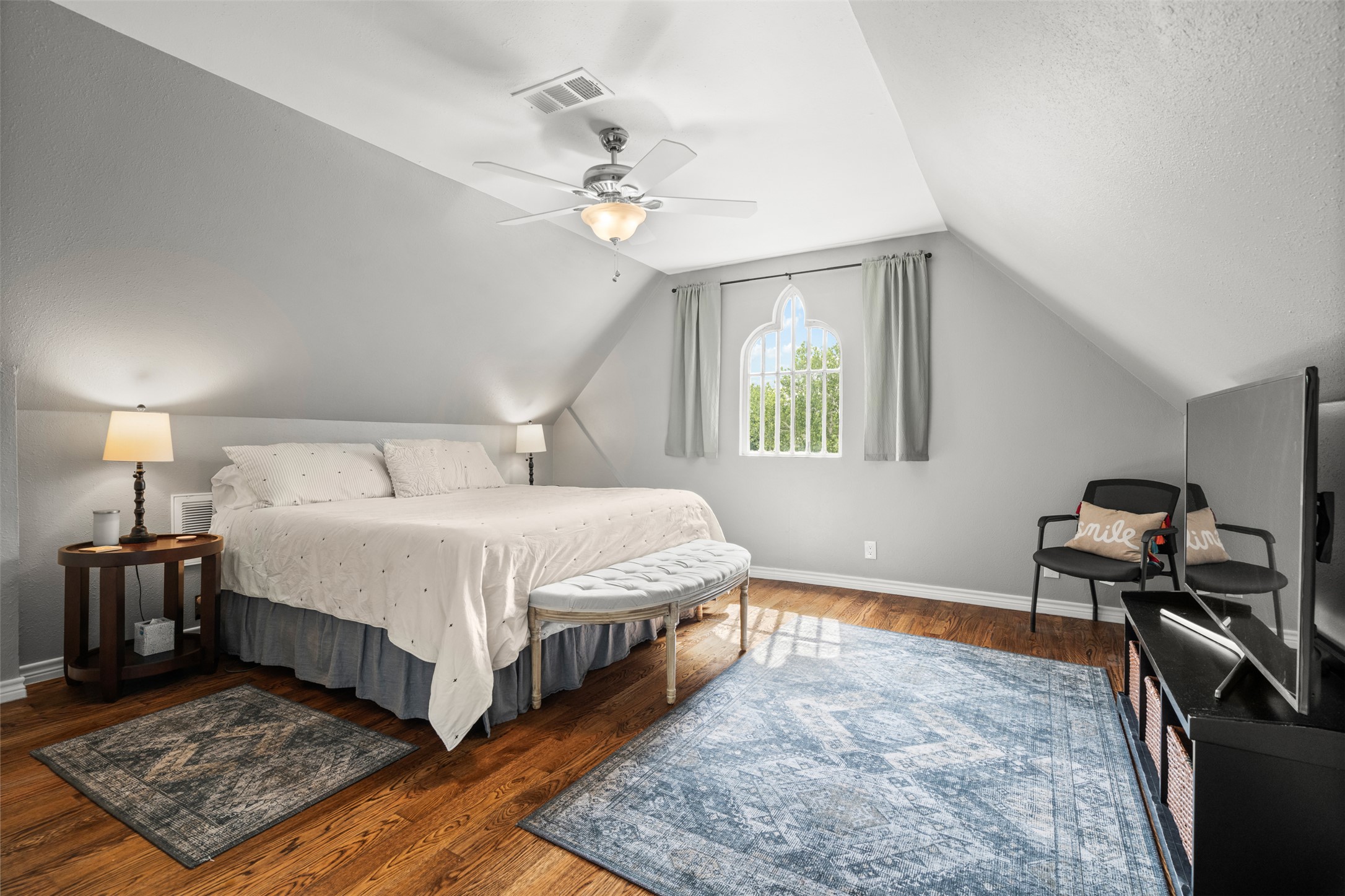 508 Main Street Marble Falls, TX 78654 - Photo 21 of 30 Third floor bedroom with lofted ceiling and vaulted ceiling with a beautiful vintage window