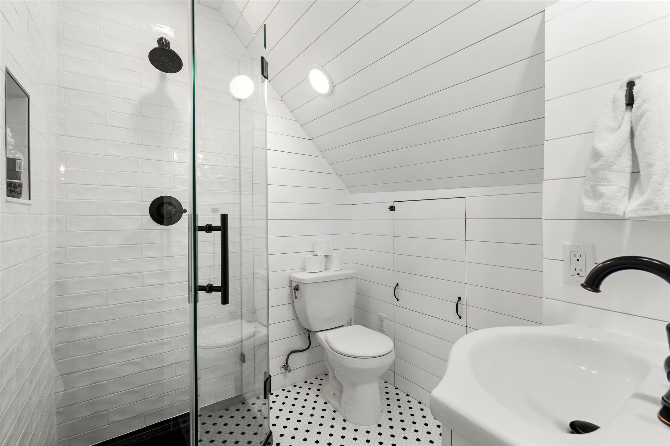 508 Main Street Marble Falls, TX 78654 - Photo 23 of 30 Third floor full bathroom featuring a sink, a stall shower, vaulted ceiling, and toilet