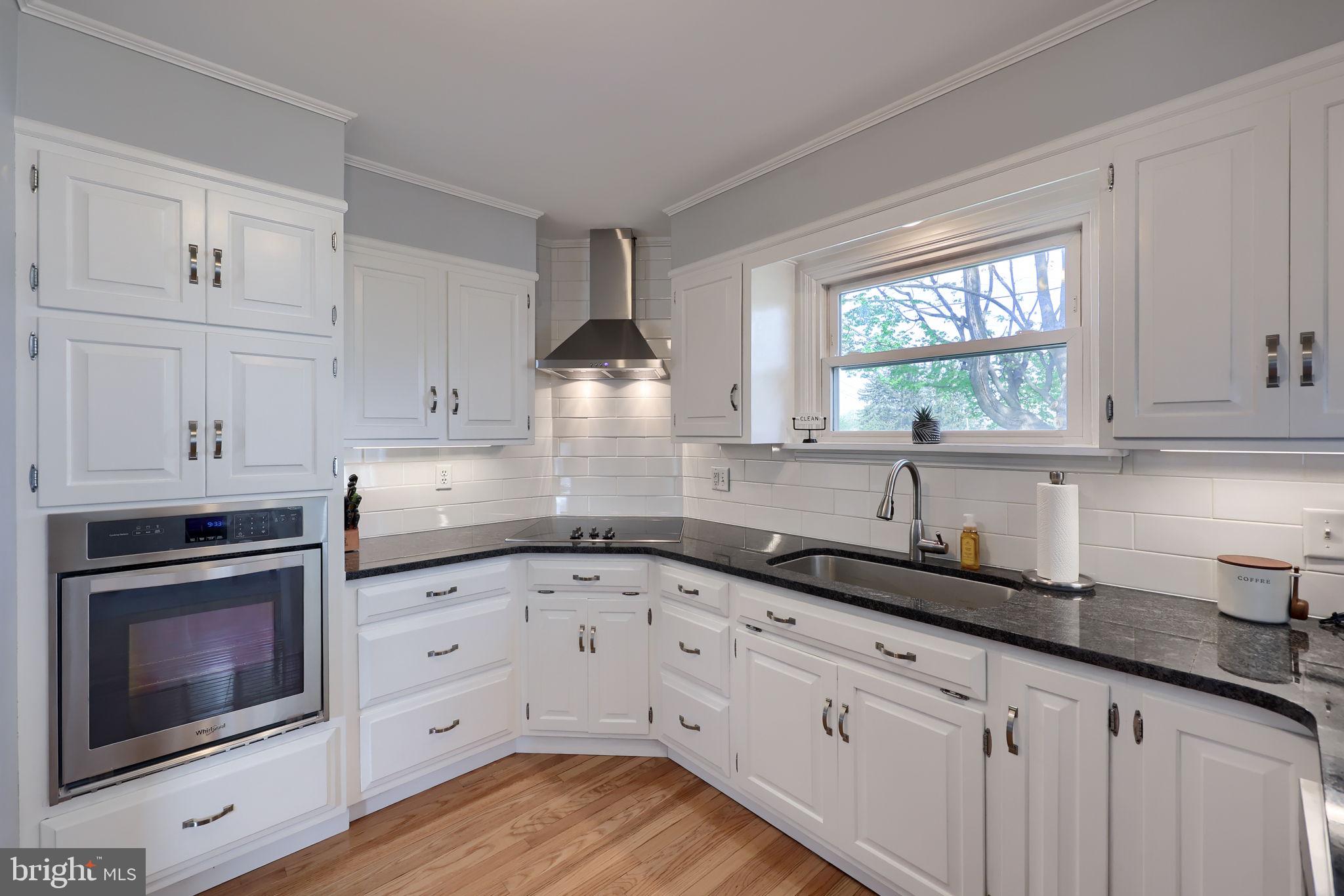 67 Oberlin Avenue Reading, PA 19608 - Photo 11 of 25 a kitchen with granite countertop white cabinets and white appliances