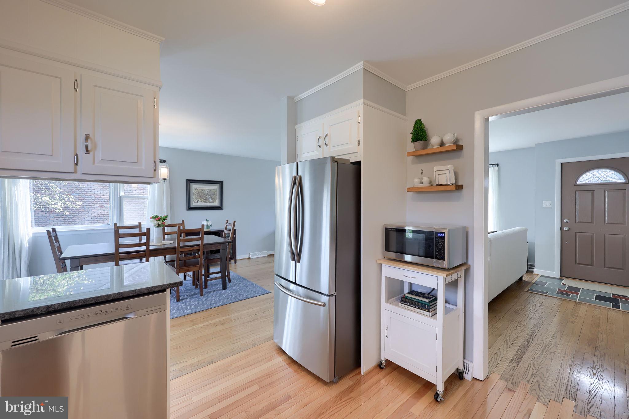 67 Oberlin Avenue Reading, PA 19608 - Photo 9 of 25 a kitchen with stainless steel appliances a refrigerator a stove a sink cabinets and wooden floor