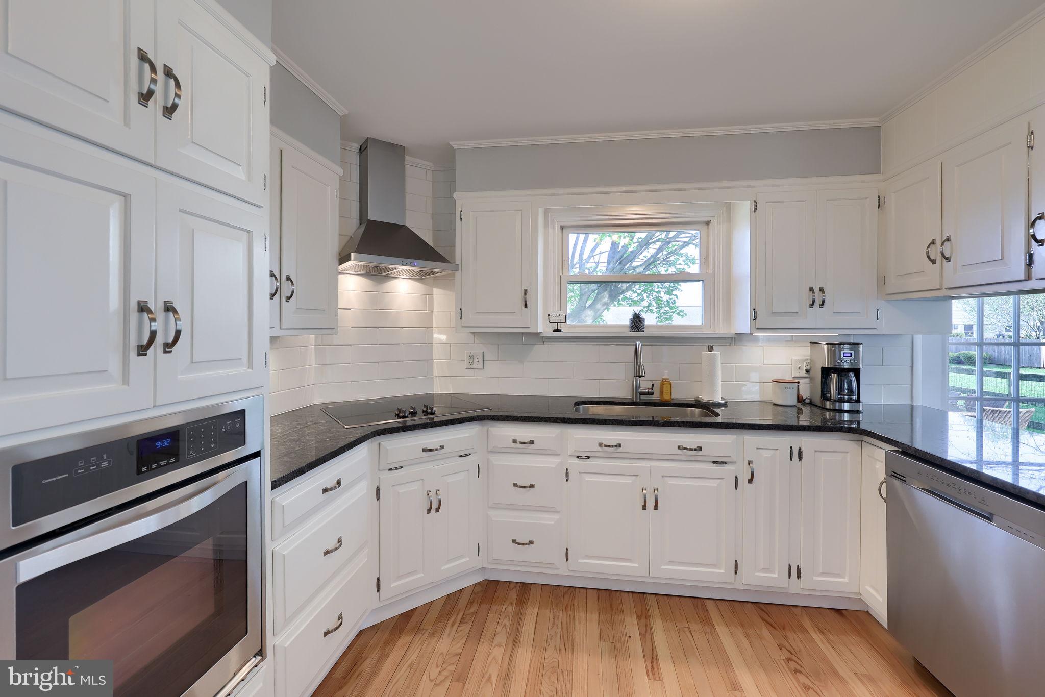 67 Oberlin Avenue Reading, PA 19608 - Photo 10 of 25 a kitchen with granite countertop white cabinets and white appliances