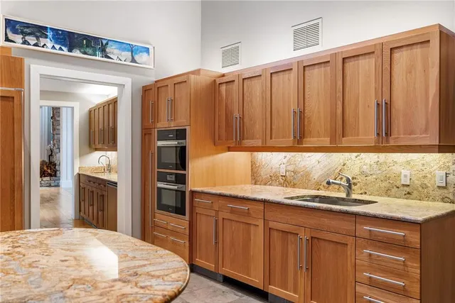 a kitchen with stainless steel appliances granite countertop a refrigerator and a sink