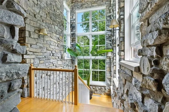 a view of a porch with a floor to ceiling window next to a yard