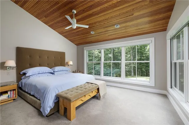 a bedroom with a large bed and a large window