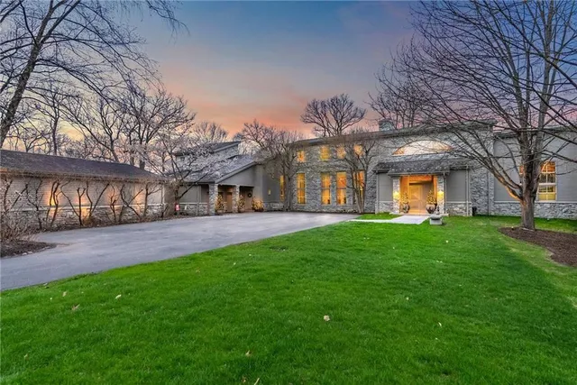 an aerial view of residential houses with outdoor space and trees