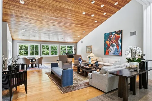 a living room with furniture and floor to ceiling windows