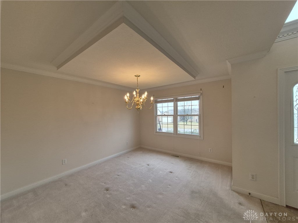 633 Orient Way Hamilton, OH 45013 - Photo 8 of 68 This versatile room features elegant crown molding and a classic chandelier, offering a bright and inviting atmosphere.