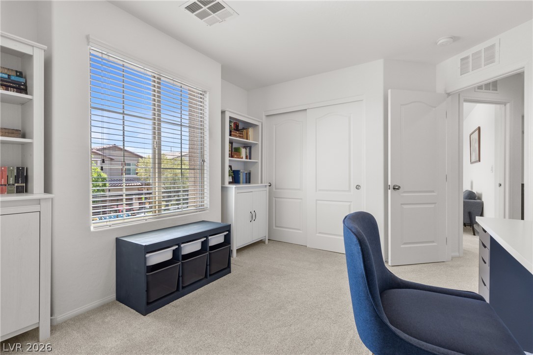 891 Earth Luster Road Las Vegas, NV 89178 - Photo 26 of 48 A well-lit room offers built-in storage solutions and plush carpeting throughout.