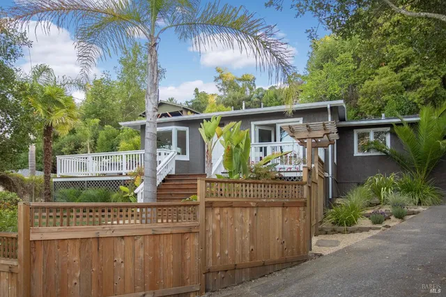 front view of house with a yard and potted plants