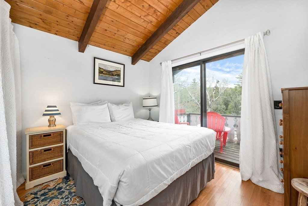 34 Linderhof Golf Course Road, Unit C12 Glen, NH 03838 - Photo 18 of 37 a bedroom with a bed and a dresser next to a window