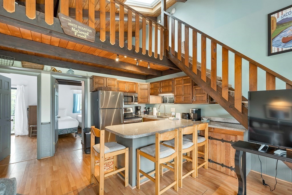 34 Linderhof Golf Course Road, Unit C12 Glen, NH 03838 - Photo 9 of 37 a view of a kitchen with furniture and wooden floor
