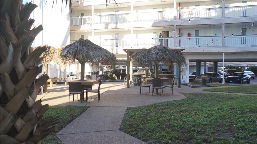 3938 Surfside Boulevard, Unit 3222 Corpus Christi, TX 78402 - Photo 2 of 9 a view of a building with a garden and sitting area