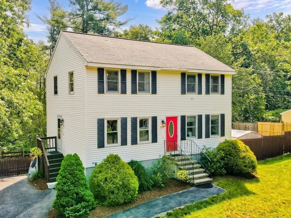 226 Allen Road Billerica, MA 01821 - Photo 1 of 25 a view of a white house with large windows and plants