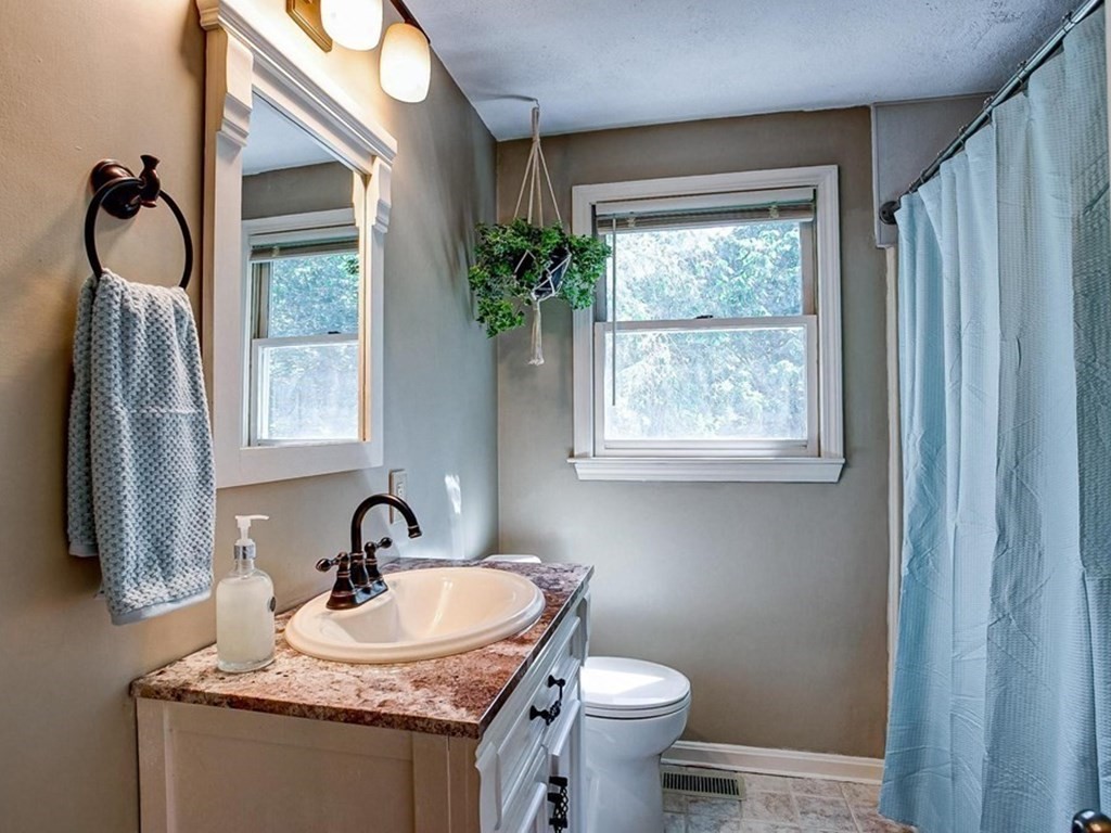 226 Allen Road Billerica, MA 01821 - Photo 16 of 25 a bathroom with a granite countertop sink and a mirror