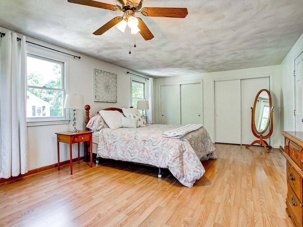 226 Allen Road Billerica, MA 01821 - Photo 20 of 25 a bedroom with a bed window and a chandelier
