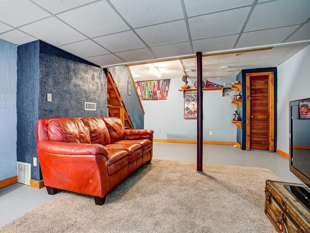 226 Allen Road Billerica, MA 01821 - Photo 22 of 25 a blue couch sitting in a room next to a window