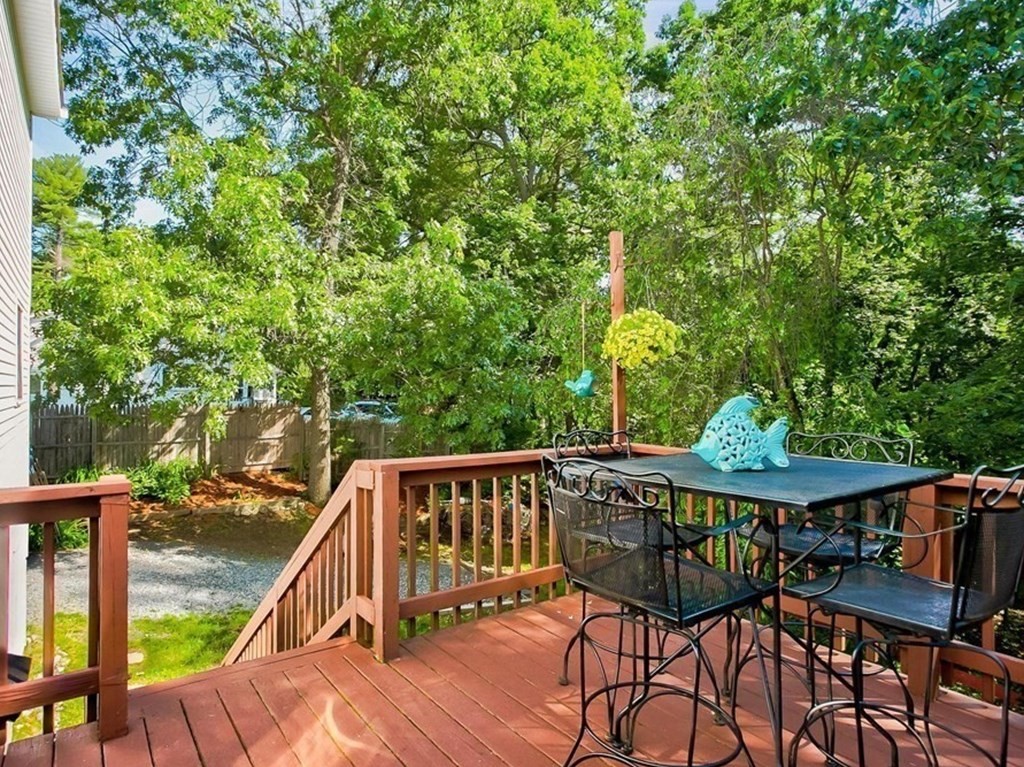 226 Allen Road Billerica, MA 01821 - Photo 23 of 25 a view of a roof deck with table and chairs with wooden floor and fence
