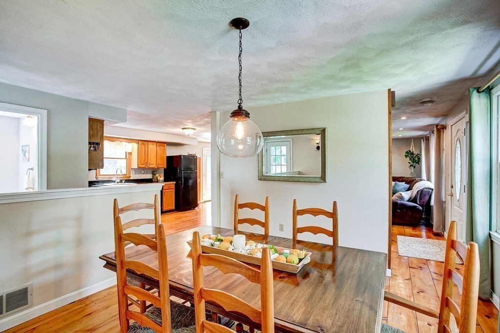 226 Allen Road Billerica, MA 01821 - Photo 7 of 25 a living room with furniture a dining table and a wooden floor